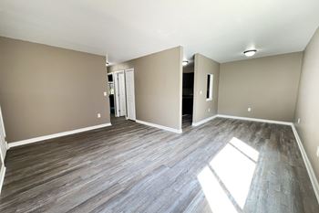 A room with wooden flooring and a white door.